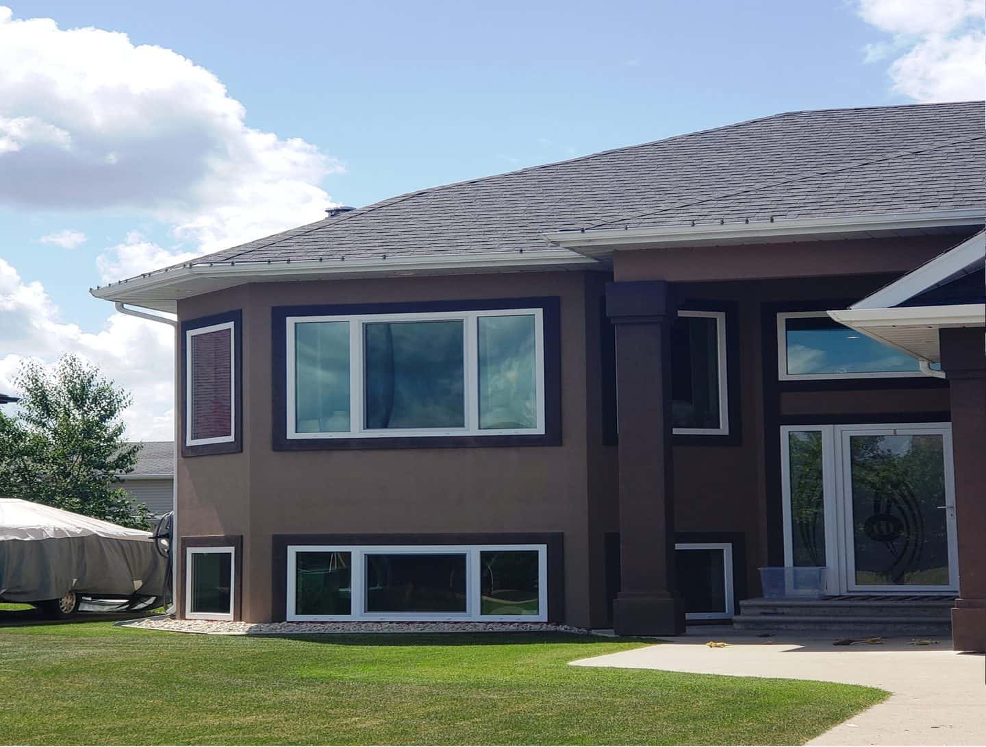 Brown house with white tilt and turn windows