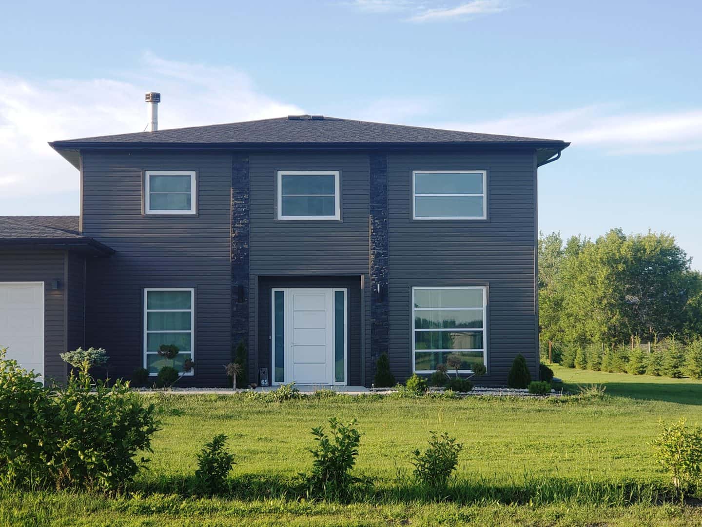 Grey house with white tilt and turn windows and door